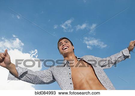 Stock Image - Smiling Caucasian man with shirt open. Fotosearch
