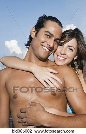Stock Image - Smiling couple hugging. Fotosearch