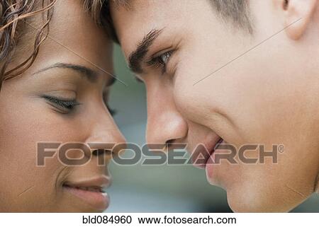 Stock Image - Smiling couple looking at each other. Fotosearch