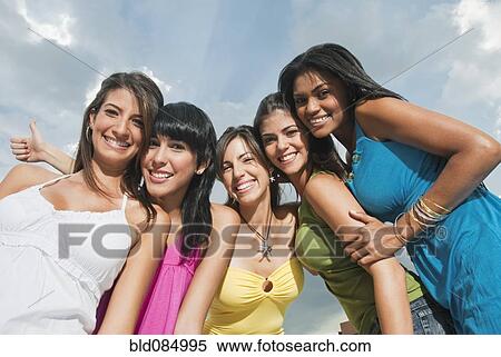 Stock Photography - Smiling friends hugging. Fotosearch