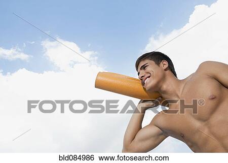Smiling Hispanic man carrying yoga mat View Large Photo Image Stock Photograph - Smiling Hispanic man carrying yoga mat. Fotosearch