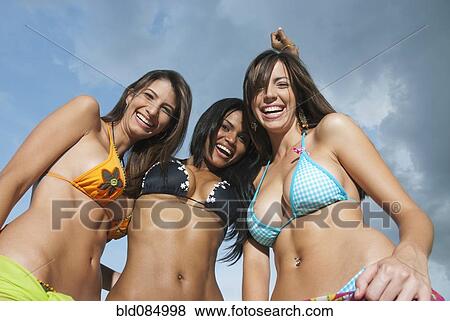 Stock Photo - Smiling women in bikinis laughing. Fotosearch