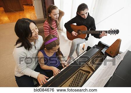 Stock Photograph - Students and teacher playing instruments. Fotosearch