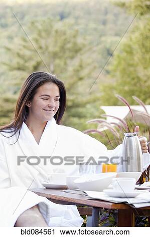 Woman enjoying breakfast on outdoor patio View Large Photo Image Stock Image - Woman enjoying breakfast on outdoor patio. Fotosearch