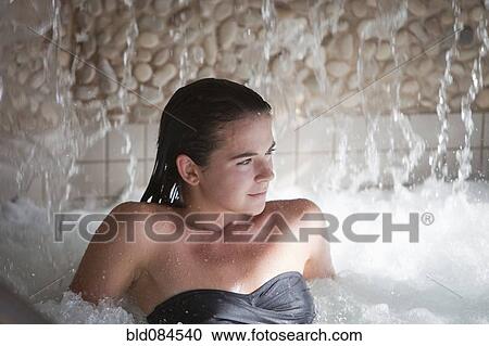Stock Image - Woman enjoying hydrotherapy treatment. Fotosearch
