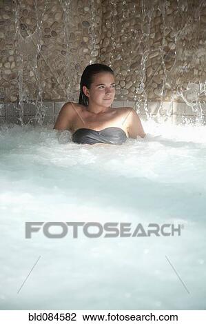 Stock Image - Woman enjoying hydrotherapy treatment. Fotosearch