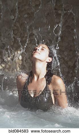 Stock Image - Woman enjoying hydrotherapy treatment. Fotosearch