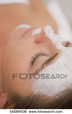 Stock Photograph - Woman having facial spa treatment. Fotosearch