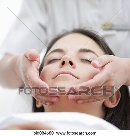 Stock Image - Woman having spa facial treatment. Fotosearch