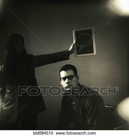Woman holding thought bubble over man's head View Large Photo Image Stock Photography - Woman holding thought bubble over man's head. Fotosearch