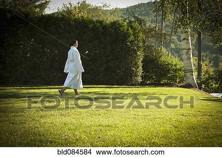 Woman walking across lawn in bathrobe View Large Photo Image Picture - Woman walking across lawn in bathrobe. Fotosearch