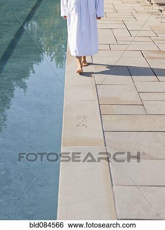 Woman walking near swimming pool View Large Photo Image Stock Photograph - Woman walking near swimming pool. Fotosearch