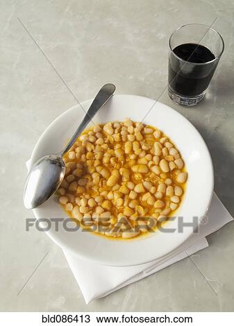 Stock Image - Bowl of Tuscan beans with tomato sauce. Fotosearch