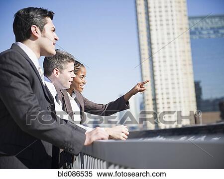 Stock Photography - Business people looking at city buildings. Fotosearch