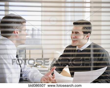 Businessmen working together in office View Large Photo Image Stock Photo - Businessmen working together in office. Fotosearch
