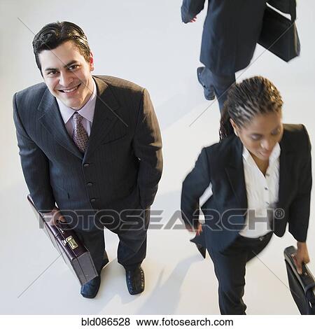Busy business people walking View Large Photo Image Stock Photo - Busy business people walking. Fotosearch