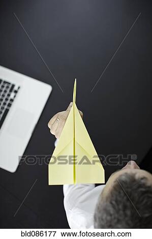 Caucasian businessman flying paper airplane View Large Photo Image Stock Photo - Caucasian businessman flying paper airplane. Fotosearch