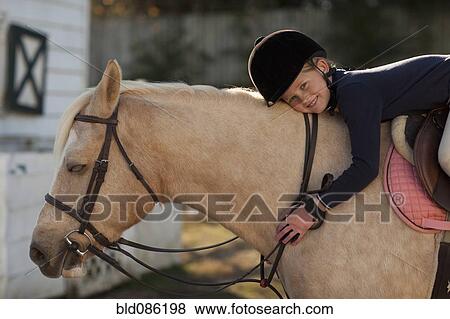 Caucasian girl riding on horse View Large Photo Image Stock Photo - Caucasian girl riding on horse. Fotosearch