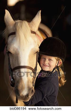 Picture - Caucasian girl standing with horse. Fotosearch