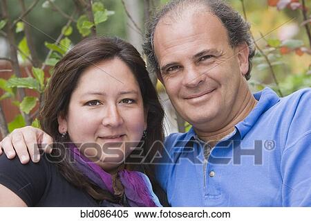 Stock Photography - Chilean couple hugging outdoors. Fotosearch