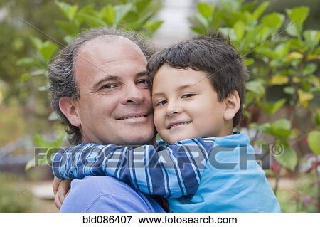 Chilean father and son hugging View Large Photo Image Stock Photo - Chilean father and son hugging. Fotosearch