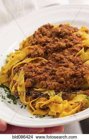 Close up of meat ragu over noodles View Large Photo Image Picture - Close up of meat ragu over noodles. Fotosearch
