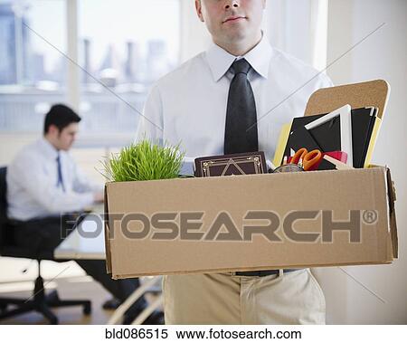 Fired Caucasian businessman carrying personal belongings View Large Photo Image Stock Photography - Fired Caucasian businessman carrying personal belongings. Fotosearch