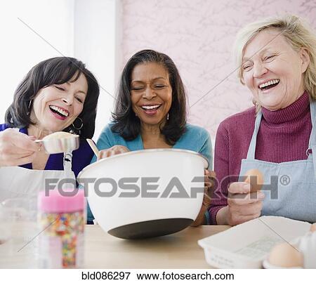 Friends baking together View Large Photo Image Stock Photo - Friends baking together. Fotosearch