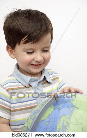 Hispanic boy looking at globe View Large Photo Image Stock Image - Hispanic boy looking at globe. Fotosearch