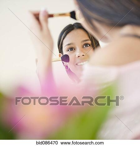 Hispanic teenager putting on blush View Large Photo Image Stock Image - Hispanic teenager putting on blush. Fotosearch
