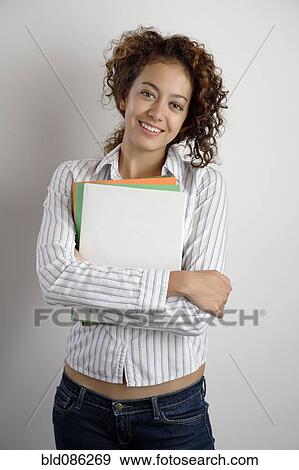 Stock Photo - Mixed race woman holding books. Fotosearch