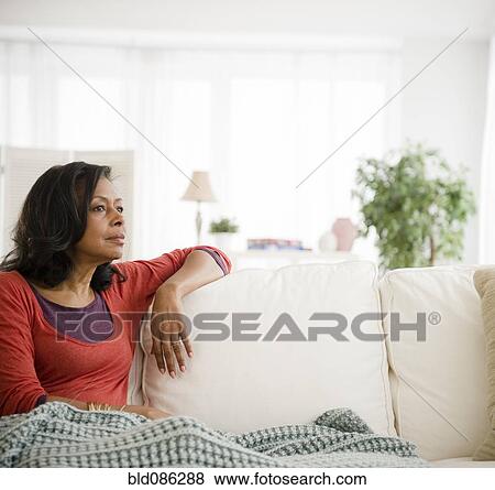 Mixed race woman laying on sofa View Large Photo Image Stock Photo - Mixed race woman laying on sofa. Fotosearch