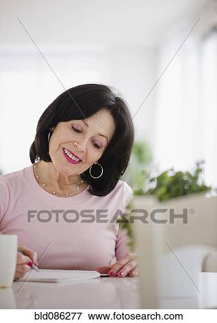 Mixed race woman writing in journal View Large Photo Image Stock Photo - Mixed race woman writing in journal. Fotosearch