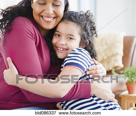Stock Photo - Mother and daughter hugging. Fotosearch