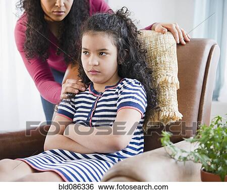 Stock Photograph - Mother comforting stubborn daughter. Fotosearch