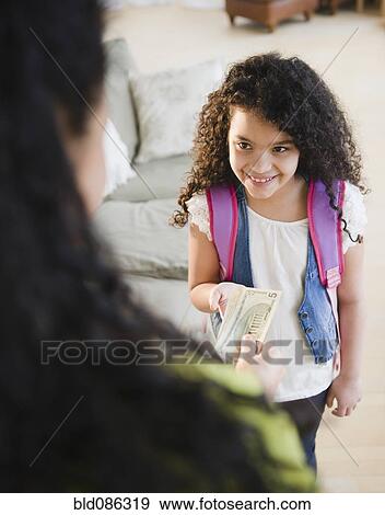 Stock Photo - Mother handing money to daughter. Fotosearch