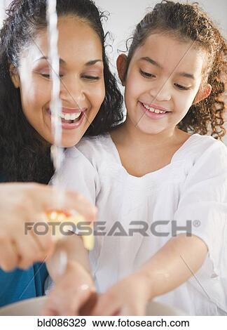 Mother helping daughter washer her hands View Large Photo Image Stock Photo - Mother helping daughter washer her hands. Fotosearch