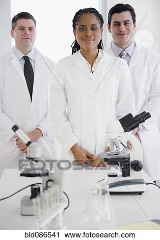 Stock Image - Scientists standing in laboratory. Fotosearch