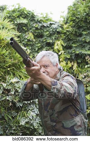 Senior Chilean man pointing shotgun View Large Photo Image Stock Image - Senior Chilean man pointing shotgun. Fotosearch