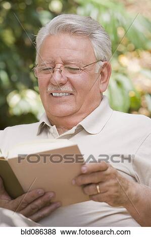 Stock Photo - Senior Chilean man reading book. Fotosearch