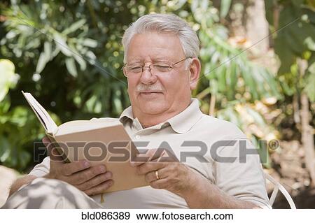 Senior Chilean man reading book View Large Photo Image Stock Photo - Senior Chilean man reading book. Fotosearch