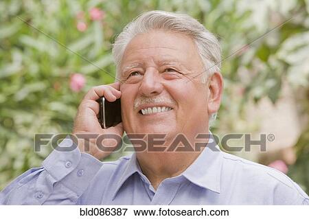 Stock Photo - Senior Chilean man using cell phone. Fotosearch