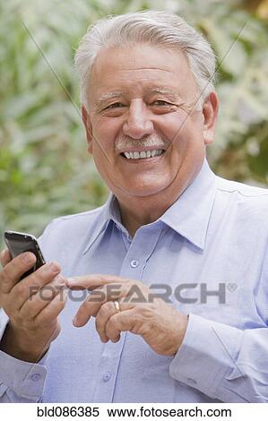 Senior Chilean man using cell phone View Large Photo Image Stock Photography - Senior Chilean man using cell phone. Fotosearch