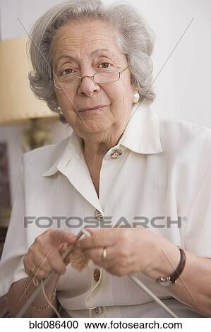 Stock Image - Senior Chilean woman knitting. Fotosearch