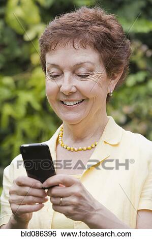 Senior Chilean woman text messaging on cell phone View Large Photo Image Stock Photograph - Senior Chilean woman text messaging on cell phone. Fotosearch