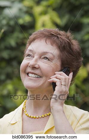 Stock Photography - Senior Chilean woman using cell phone. Fotosearch