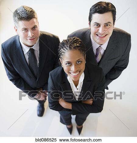Stock Photography - Smiling business people standing together. Fotosearch