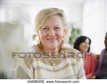 Smiling Caucasian woman with friends View Large Photo Image Stock Image - Smiling Caucasian woman with friends. Fotosearch