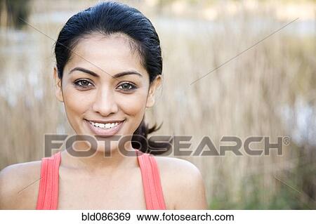 Smiling Indian woman outdoors View Large Photo Image Stock Photo - Smiling Indian woman outdoors. Fotosearch