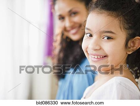 Stock Image - Smiling mother and daughter. Fotosearch